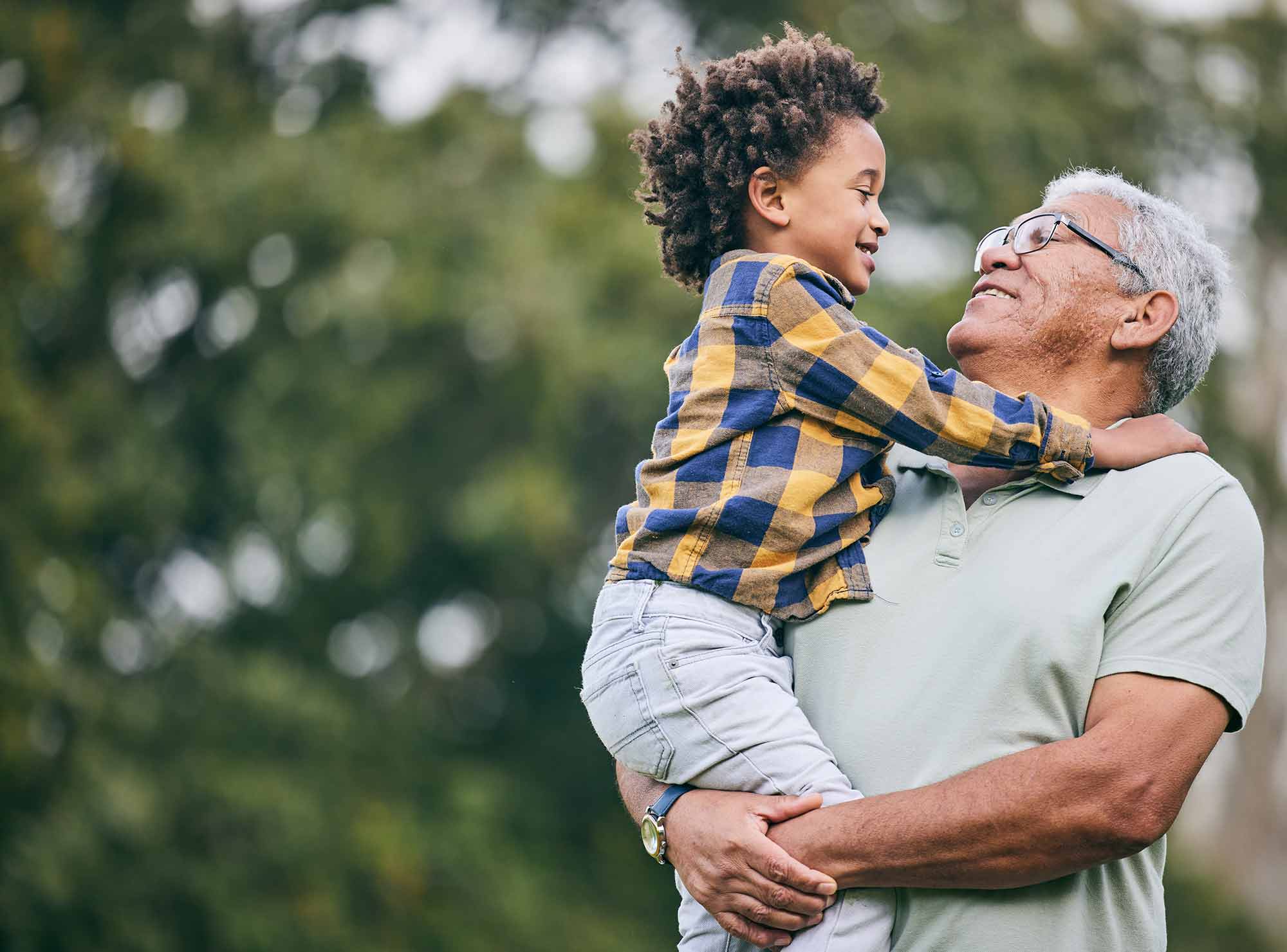 Grandfather holding his grandson and smiling