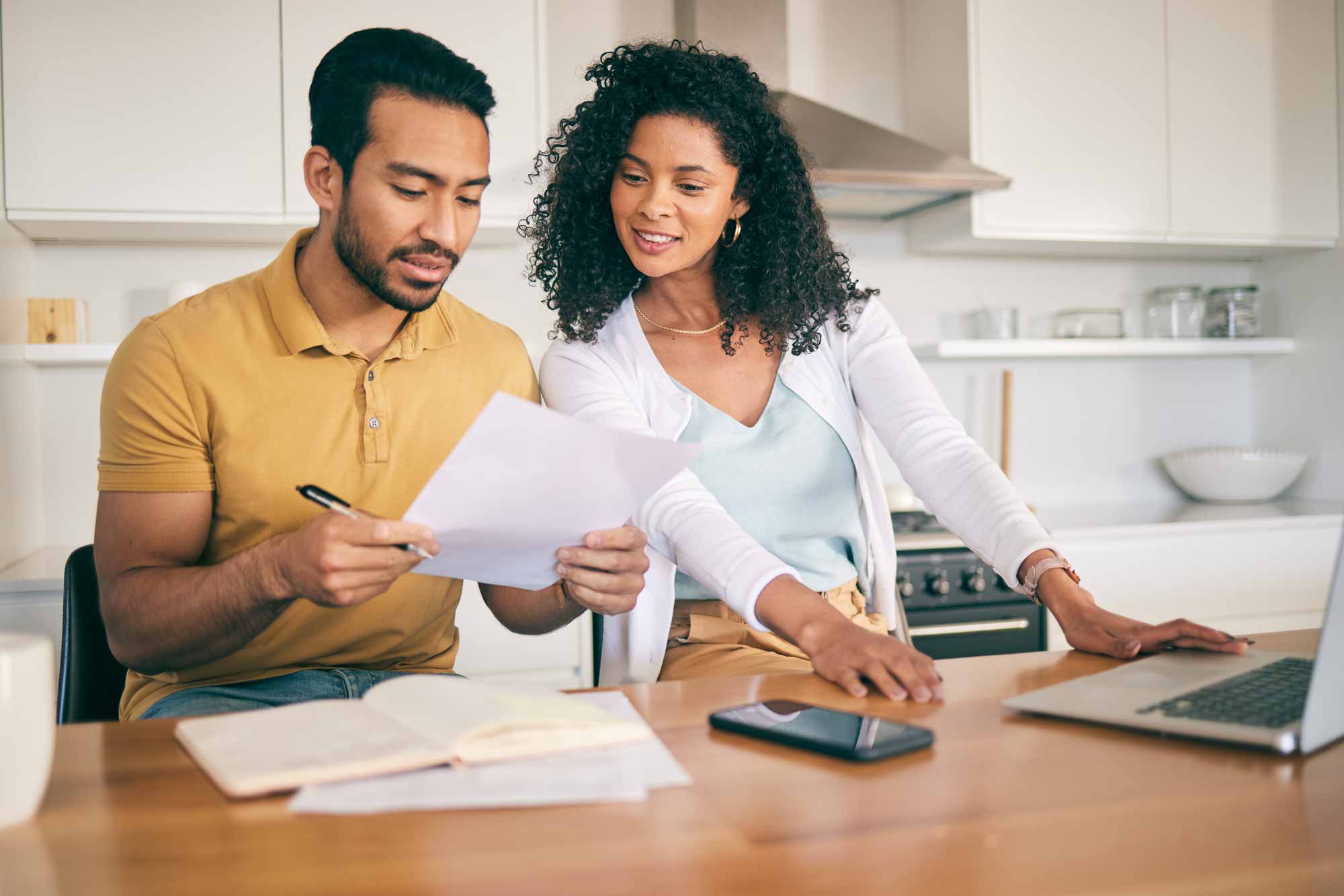 A couple looking over their taxes at the kitchen table